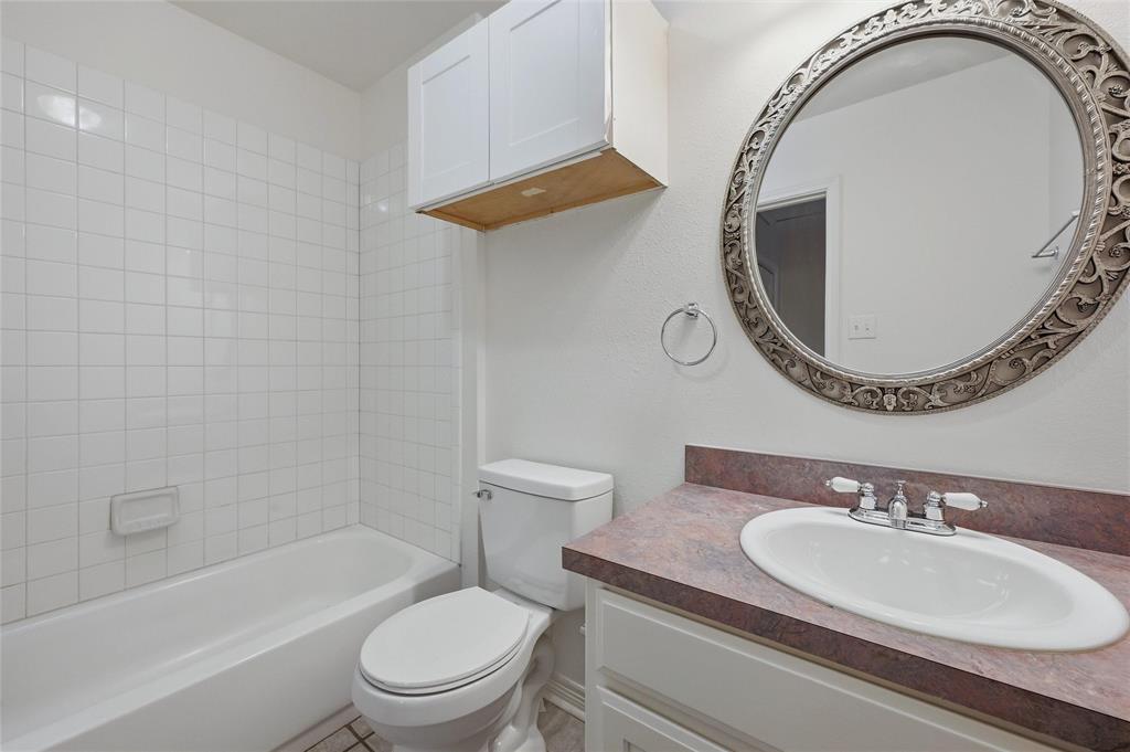 2418 Loy Lake Road Denison, TX 75020 - Photo 15 of 23 a bathroom with a sink and a mirror