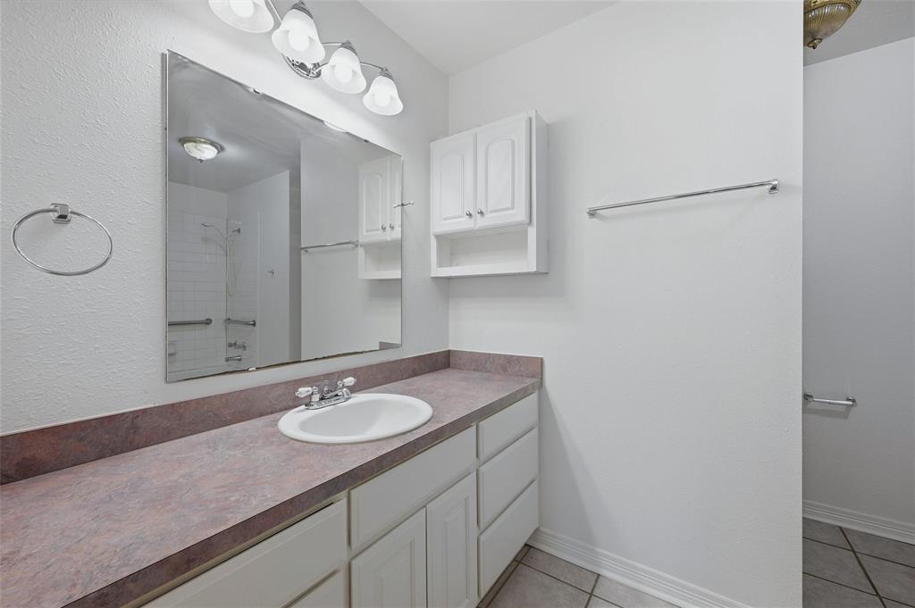 2418 Loy Lake Road Denison, TX 75020 - Photo 18 of 23 a bathroom with a sink vanity granite and a mirror