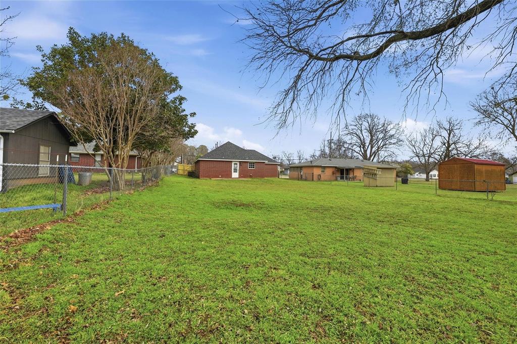 2418 Loy Lake Road Denison, TX 75020 - Photo 22 of 23 a view of a house with a yard