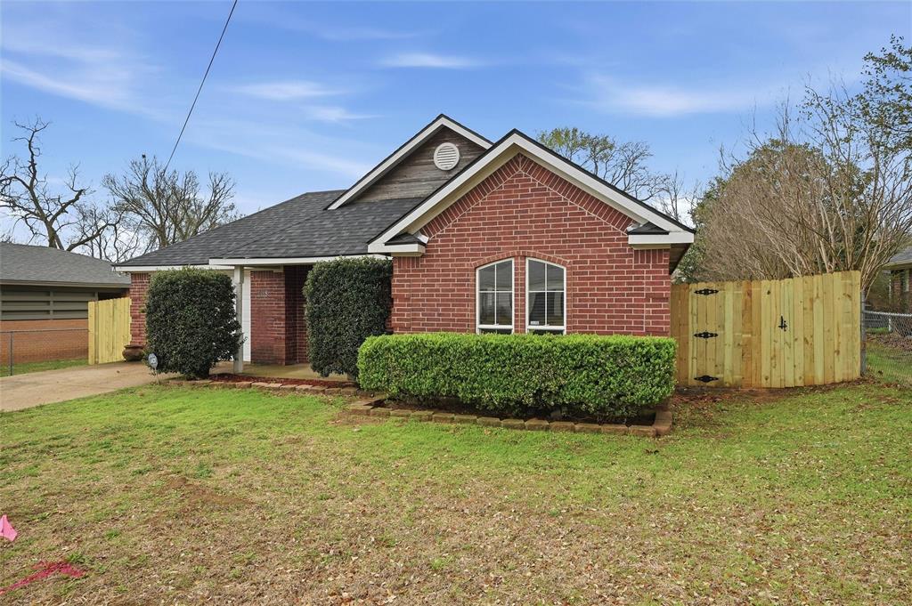 2418 Loy Lake Road Denison, TX 75020 - Photo 3 of 23 a front view of a house with a yard