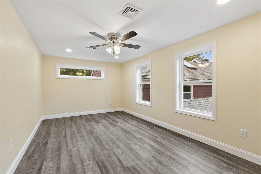 20 Townsend Street, Unit 1 Pepperell, MA 01463 - Photo 11 of 25 a view of an empty room with a window and wooden floor