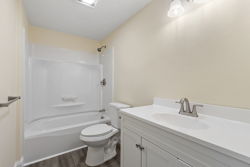20 Townsend Street, Unit 1 Pepperell, MA 01463 - Photo 17 of 25 a bathroom with a sink a toilet and shower