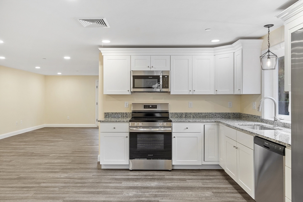 20 Townsend Street, Unit 1 Pepperell, MA 01463 - Photo 2 of 25 a kitchen with a stove and a sink
