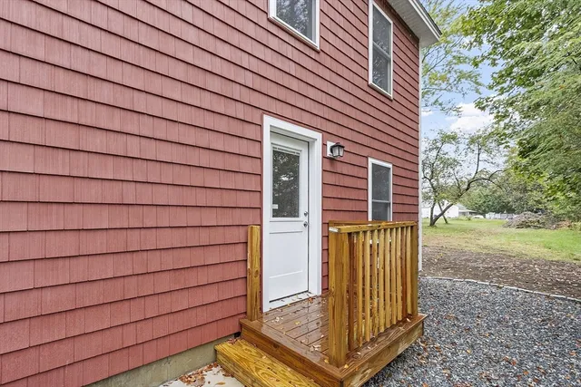 a view of a house with a door and wooden floor