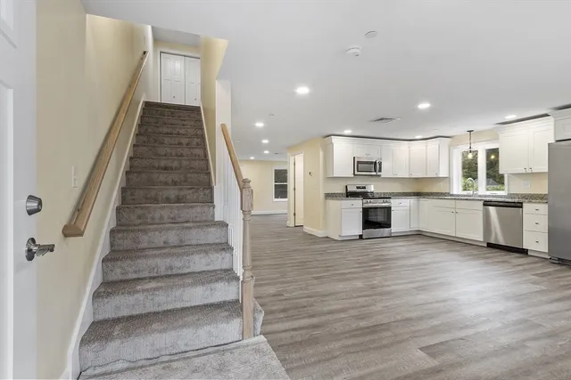 a view of kitchen with wooden floor and electronic appliances