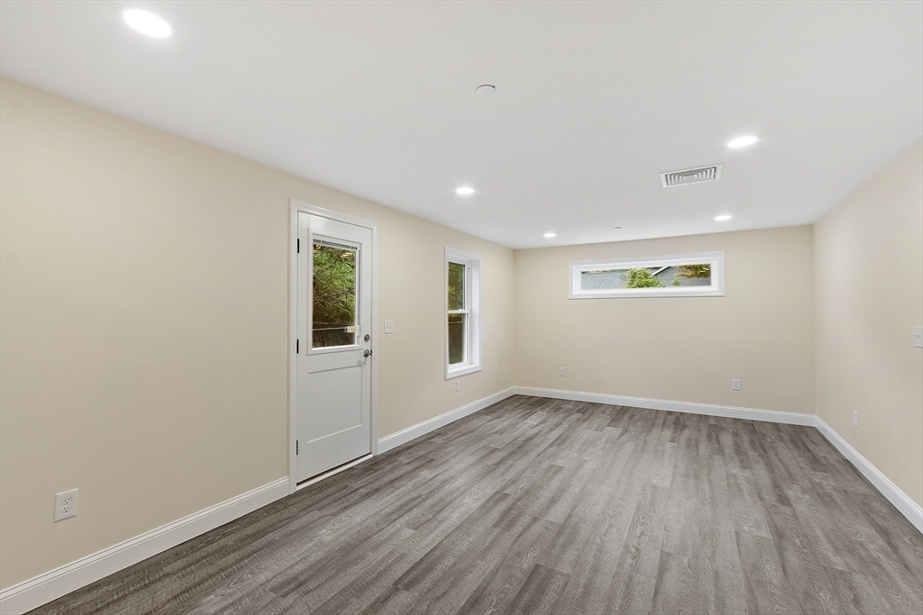 20 Townsend Street, Unit 1 Pepperell, MA 01463 - Photo 8 of 25 wooden floor in an empty room with a window