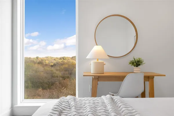a bedroom with a bed and a mirror