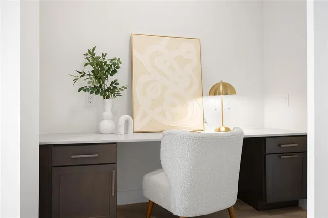 a living room with a sink and a potted plant