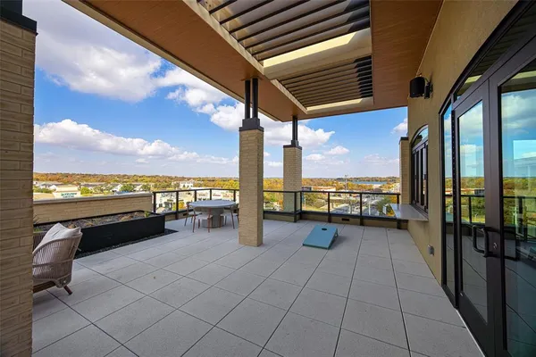 a view of balcony with couch and chairs