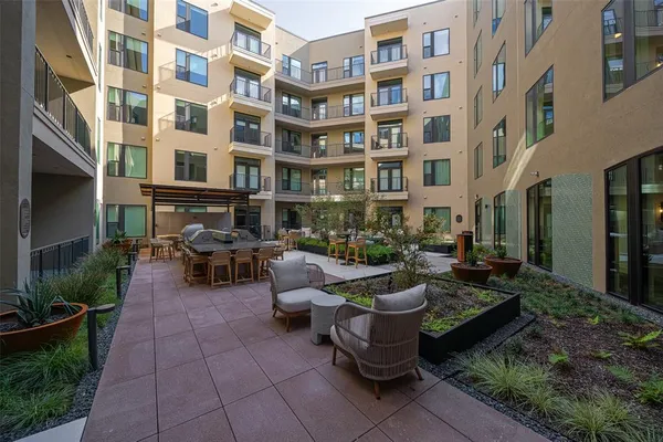 a view of a patio filled with furniture and a potted plants