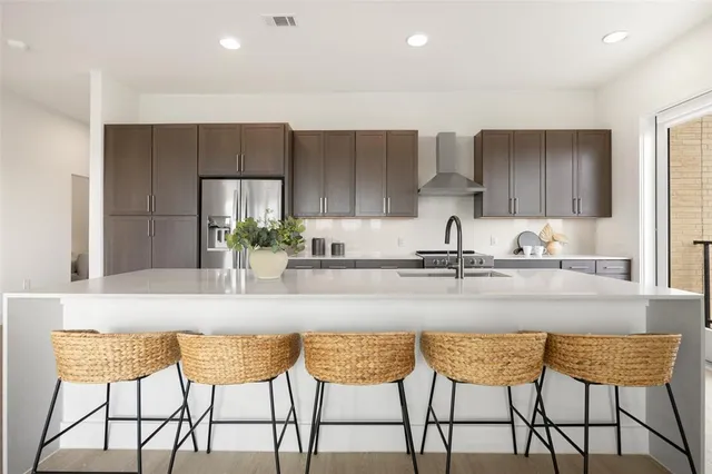 a kitchen with a table chairs and cabinets