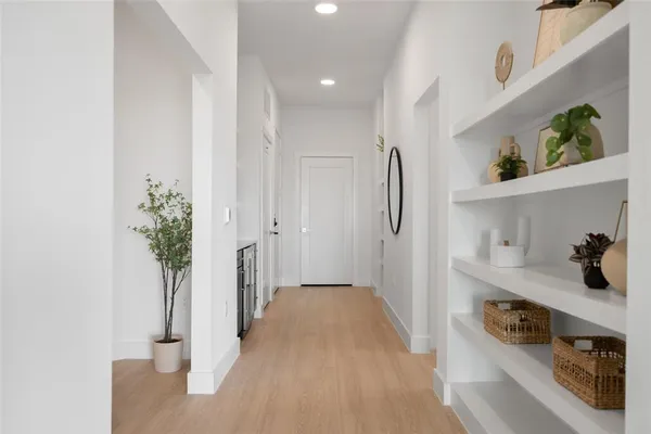 a view of hallway with seating and hardwood floor