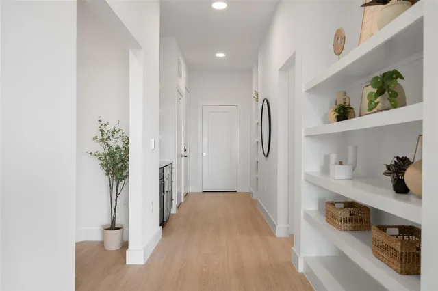 a view of hallway with seating and hardwood floor