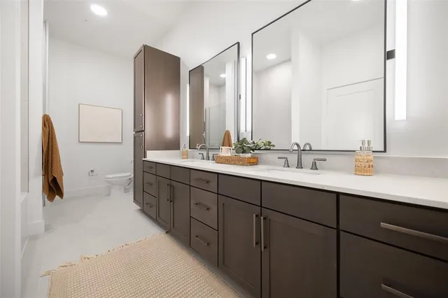 a bathroom with a double vanity sink and mirror