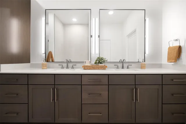 a bathroom with a double vanity sink and a mirror
