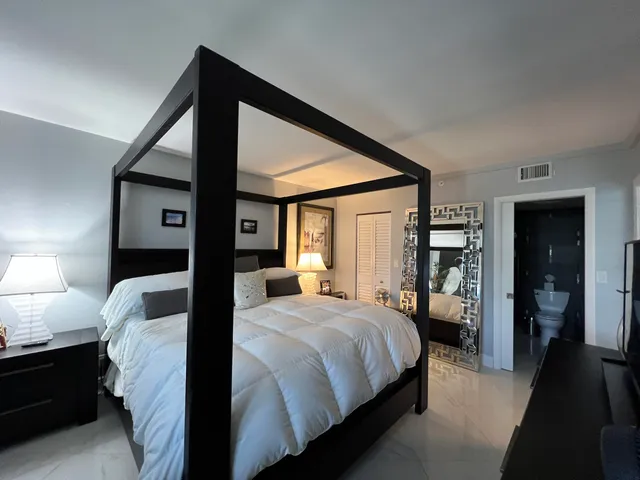 a bathroom with a sink a toilet a mirror and a shower