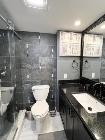 a bathroom with a toilet sink and shower