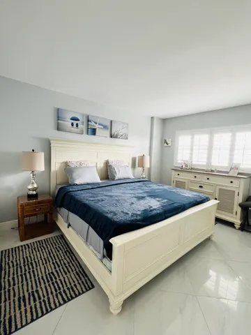 a view of a chairs and table in the back yard