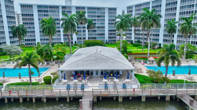 a view of a house with pool and chairs