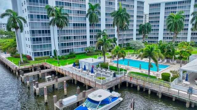 a view of swimming pool with outdoor seating and plants