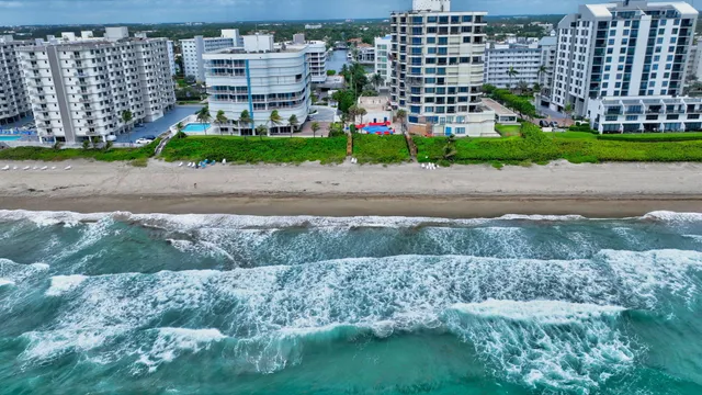 a view of kitchen with stainless steel appliances kitchen island granite countertop lots of white cabinets