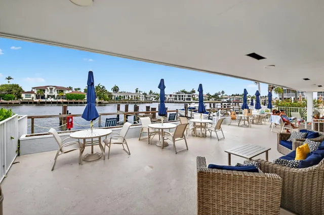 a view of a building with a big yard and large trees