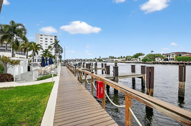 a view of a tall building with a yard and plants
