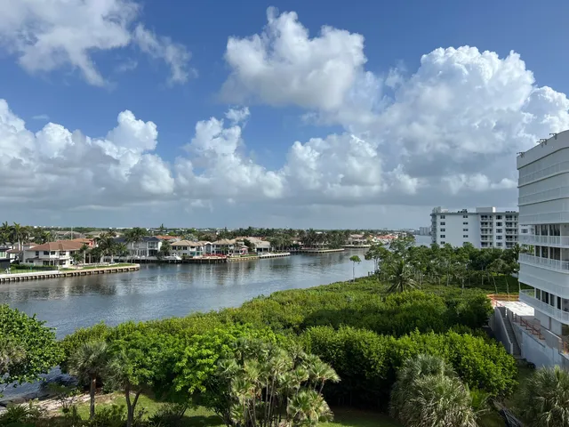 a view of a lake with houses in back
