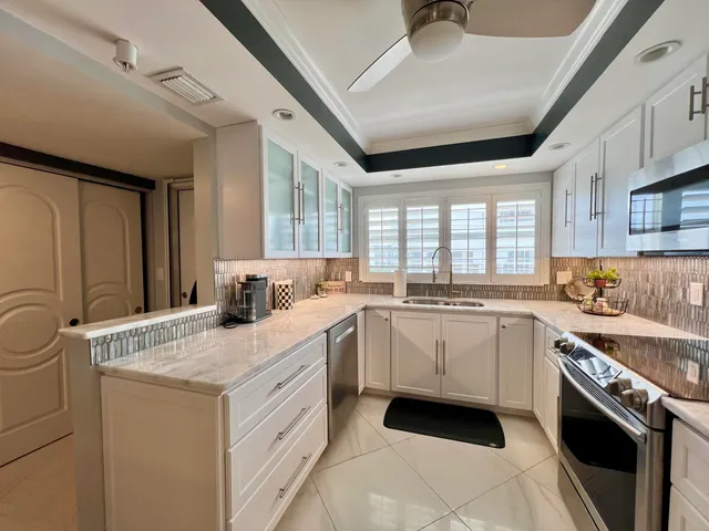 a kitchen with sink a window and cabinets