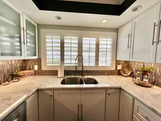a large kitchen with a table and chairs in it