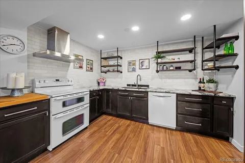 a kitchen with stainless steel appliances a stove top oven and cabinets