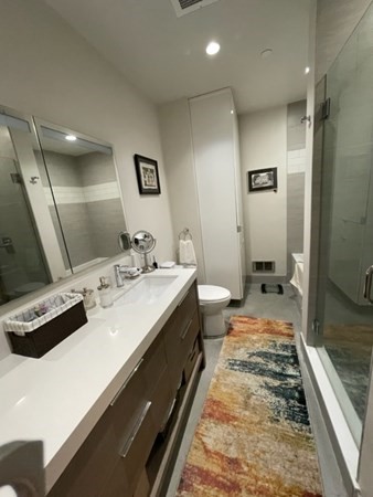 35 Channel Center Street, Unit 211 Boston, MA 02210 - Photo 11 of 11 a spacious bathroom with a double vanity sink and a mirror