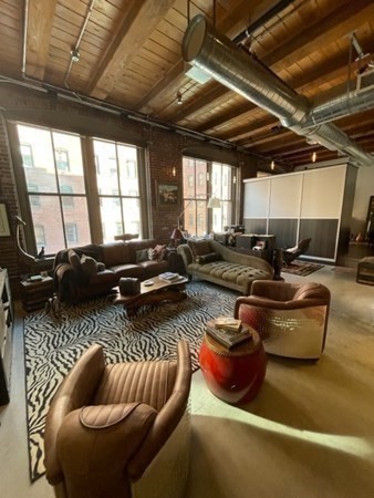 35 Channel Center Street, Unit 211 Boston, MA 02210 - Photo 2 of 11 a living room with furniture and a large window