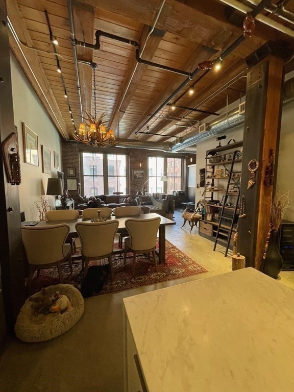 35 Channel Center Street, Unit 211 Boston, MA 02210 - Photo 3 of 11 a room with lots of chairs a chandelier and pool table