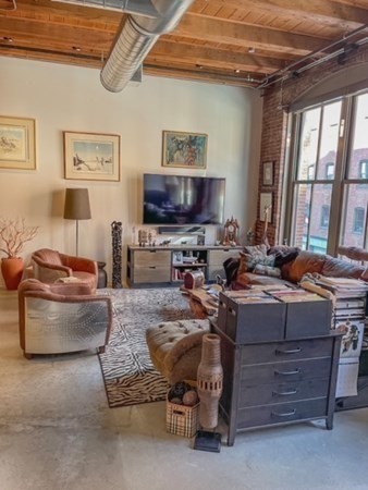 35 Channel Center Street, Unit 211 Boston, MA 02210 - Photo 4 of 11 a living room with furniture and a flat screen tv
