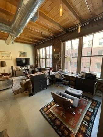 a living room with furniture and a floor to ceiling window
