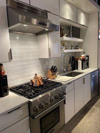 35 Channel Center Street, Unit 211 Boston, MA 02210 - Photo 8 of 11 a stove top oven sitting inside of a kitchen