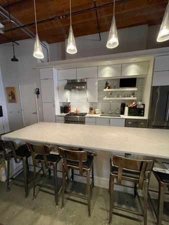35 Channel Center Street, Unit 211 Boston, MA 02210 - Photo 9 of 11 a kitchen with a table and chairs in it