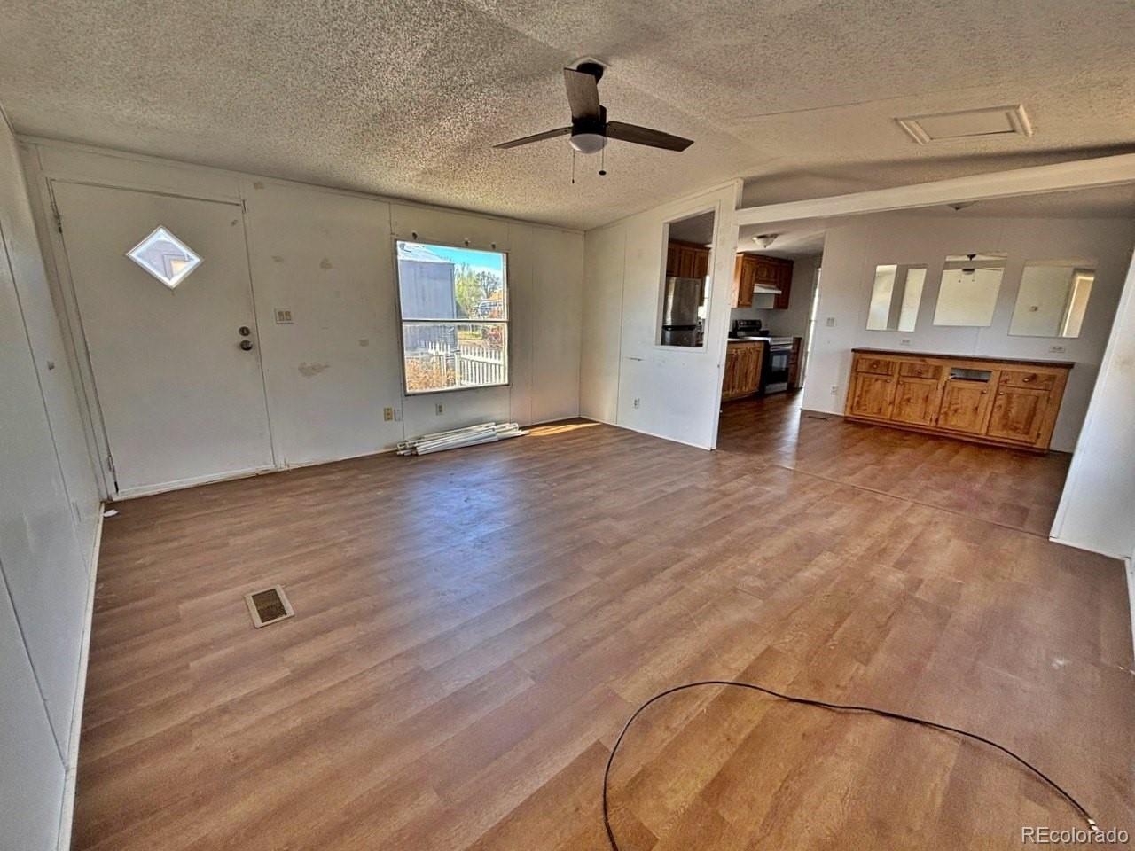 1205 Reed Lane La Junta, CO 81050 - Photo 26 of 26 wooden floor in an empty room with a window