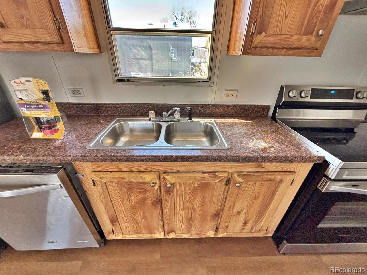 1205 Reed Lane La Junta, CO 81050 - Photo 8 of 26 a kitchen with a sink stove and microwave