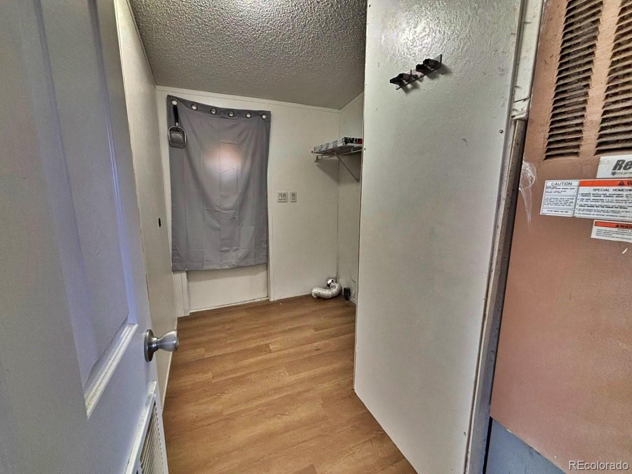 1205 Reed Lane La Junta, CO 81050 - Photo 10 of 26 a view of a hallway with wooden floor and closet