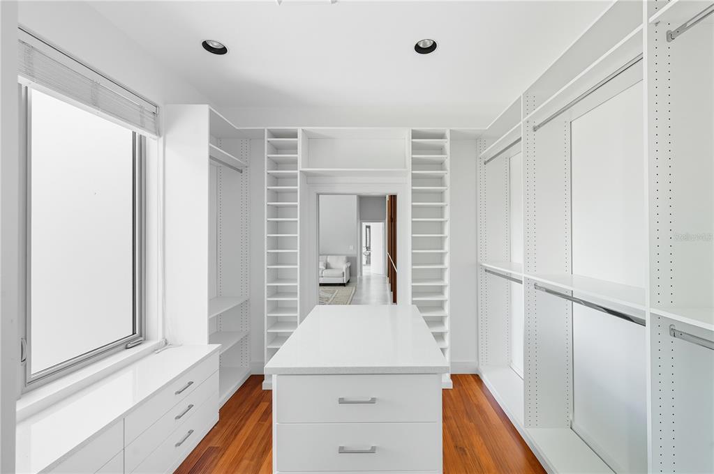 3315 Bay Shore Road Sarasota, FL 34234 - Photo 49 of 96 a view of a kitchen with white cabinets and wooden floor