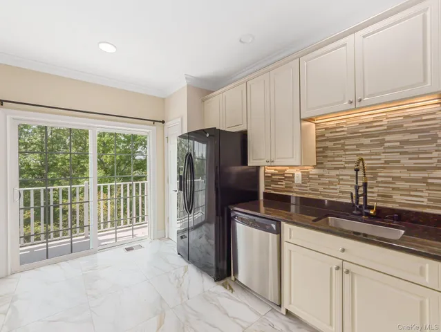 a kitchen with stainless steel appliances granite countertop a refrigerator and a sink