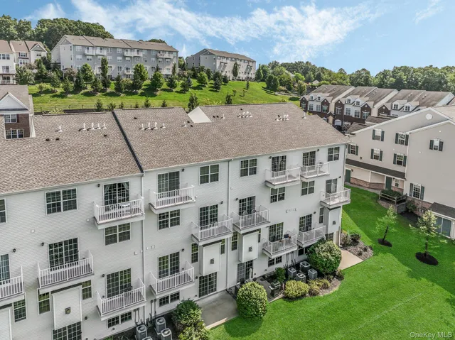 a view of a white house with many windows