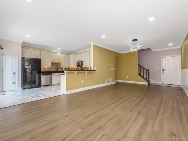 a view of a kitchen with a sink and a refrigerator