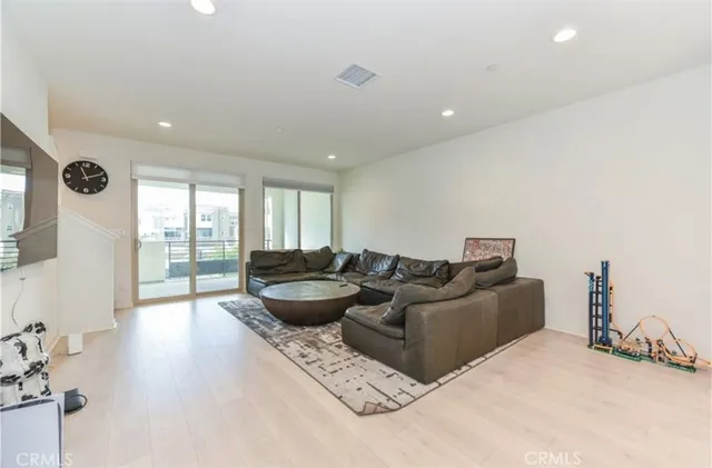 a living room with furniture window and wooden floor