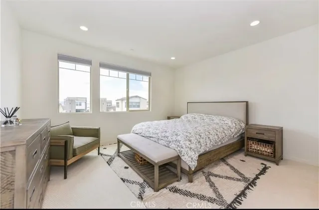 a bedroom with a bed a table and a dresser