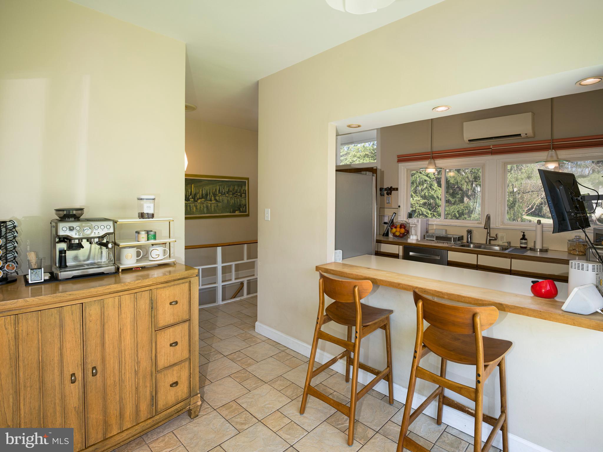 1321 Pepper Road Rydal, PA 19046 - Photo 21 of 49 a kitchen with stainless steel appliances granite countertop a table and chairs in it