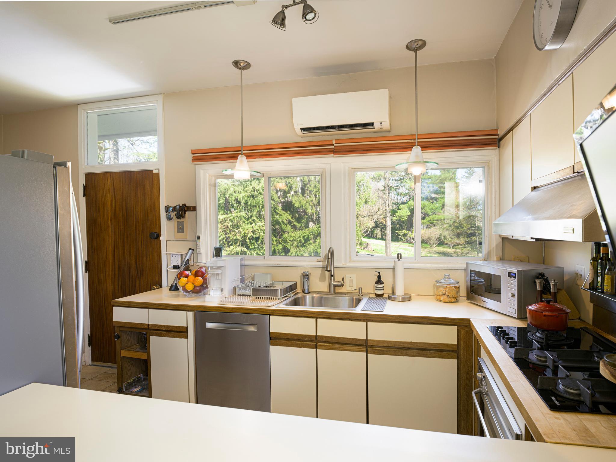 1321 Pepper Road Rydal, PA 19046 - Photo 23 of 49 a kitchen with stainless steel appliances kitchen island granite countertop a sink stove and refrigerator