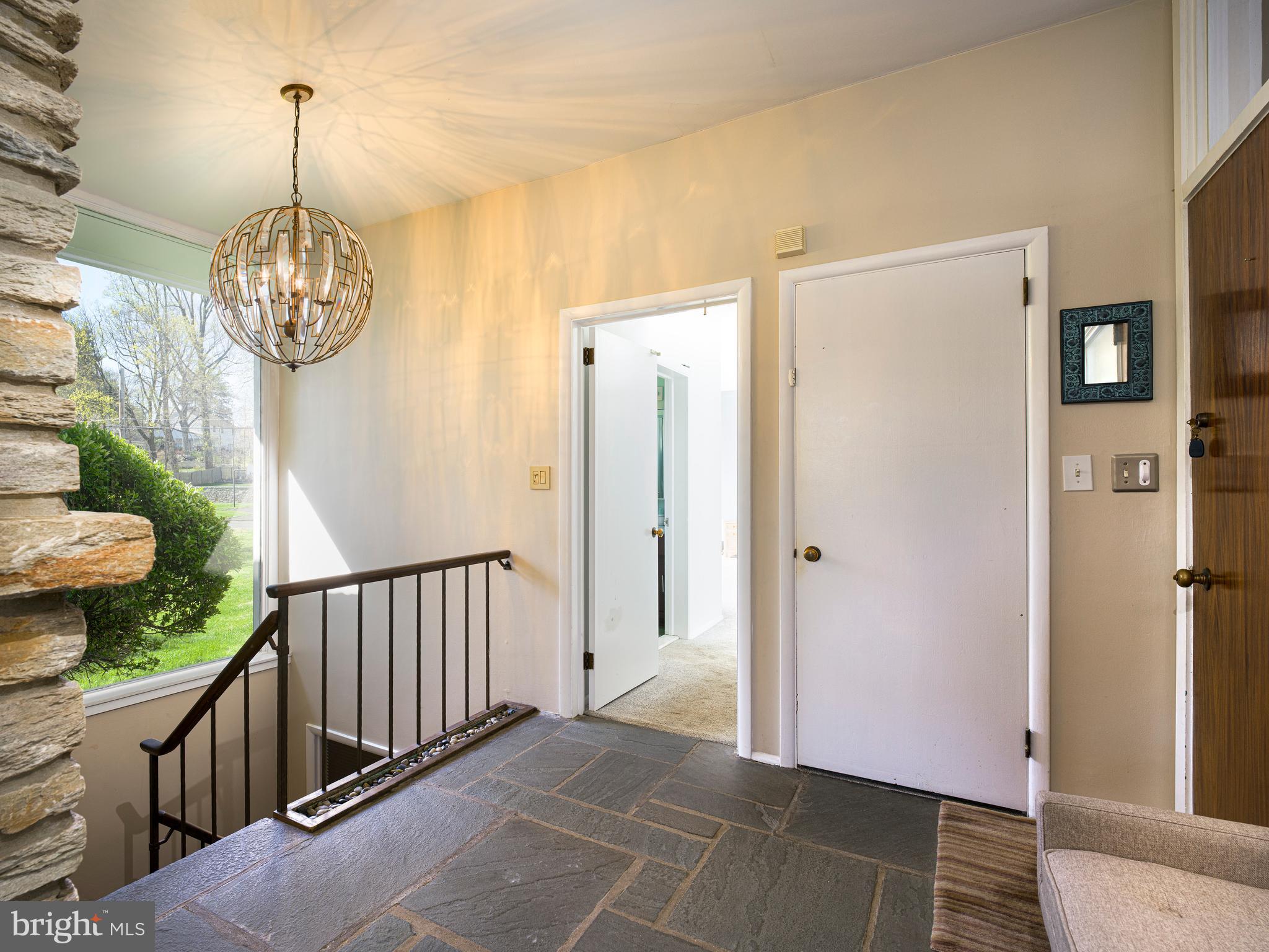 1321 Pepper Road Rydal, PA 19046 - Photo 10 of 49 a view of a hallway to dining room and chandelier
